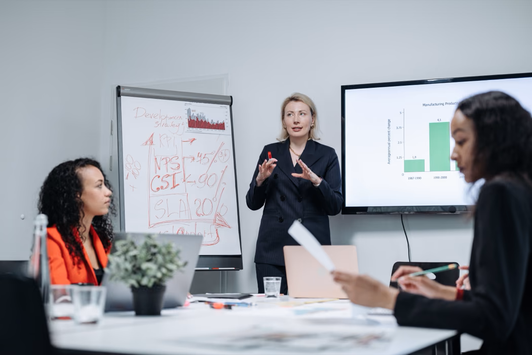 Woman in Black Blazer Presenting in a Meeting · Free Stock Photo