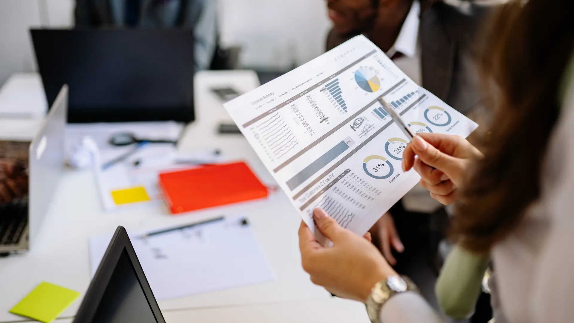 Professionals reviewing business charts and documents in a team meeting