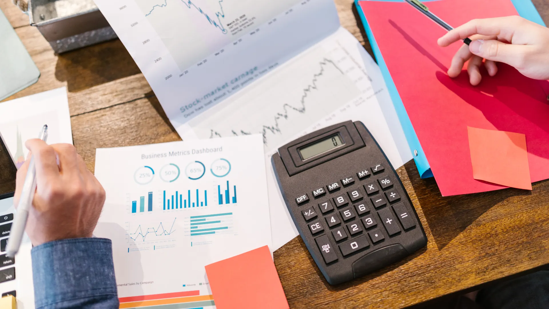 Financial analysis and planning tools with graphs and calculator on a table
