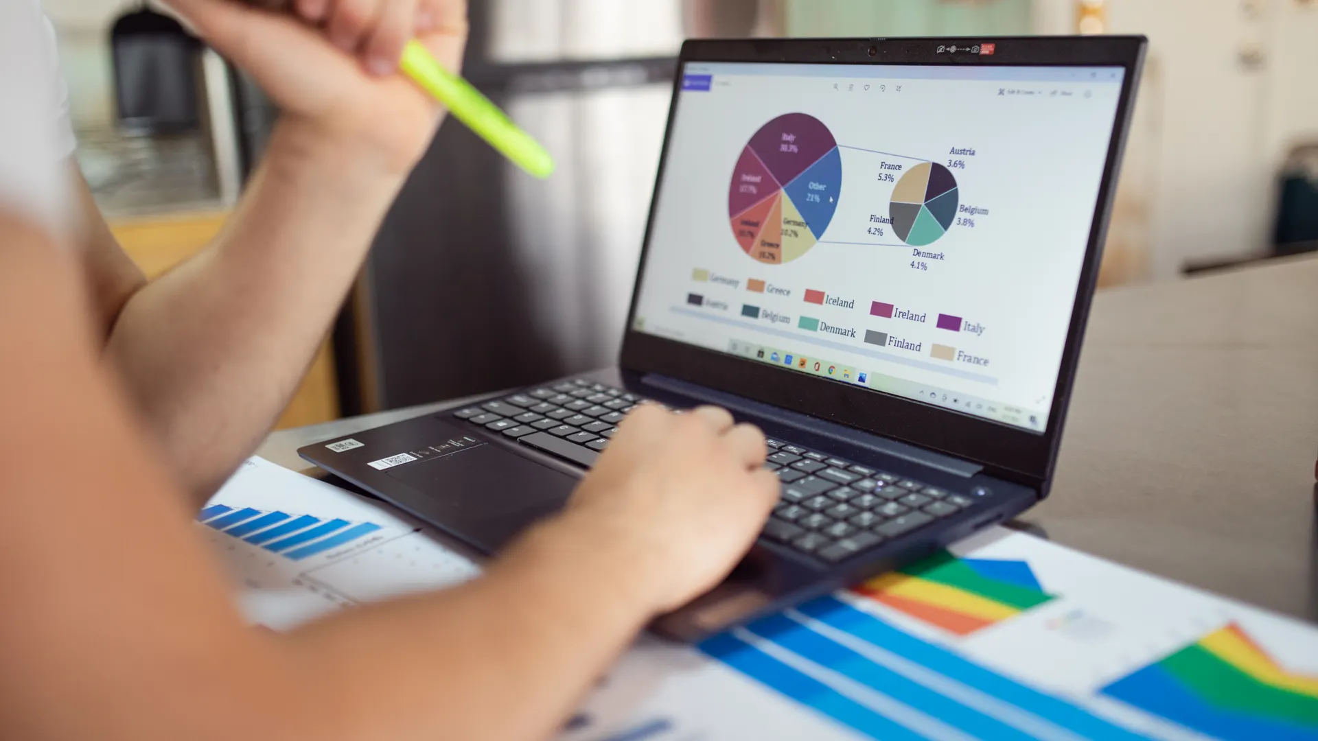 Person analyzing financial charts and graphs on a laptop