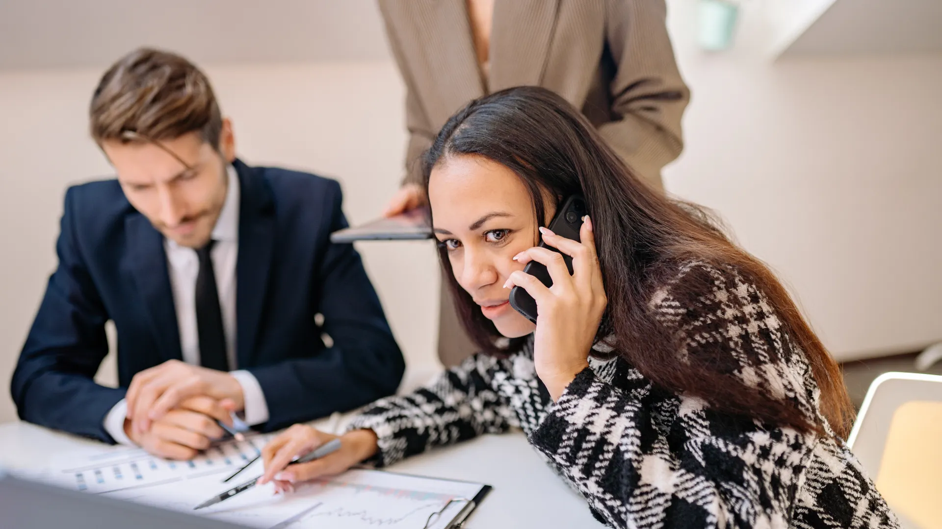 Professional meeting with focused teamwork and phone communication