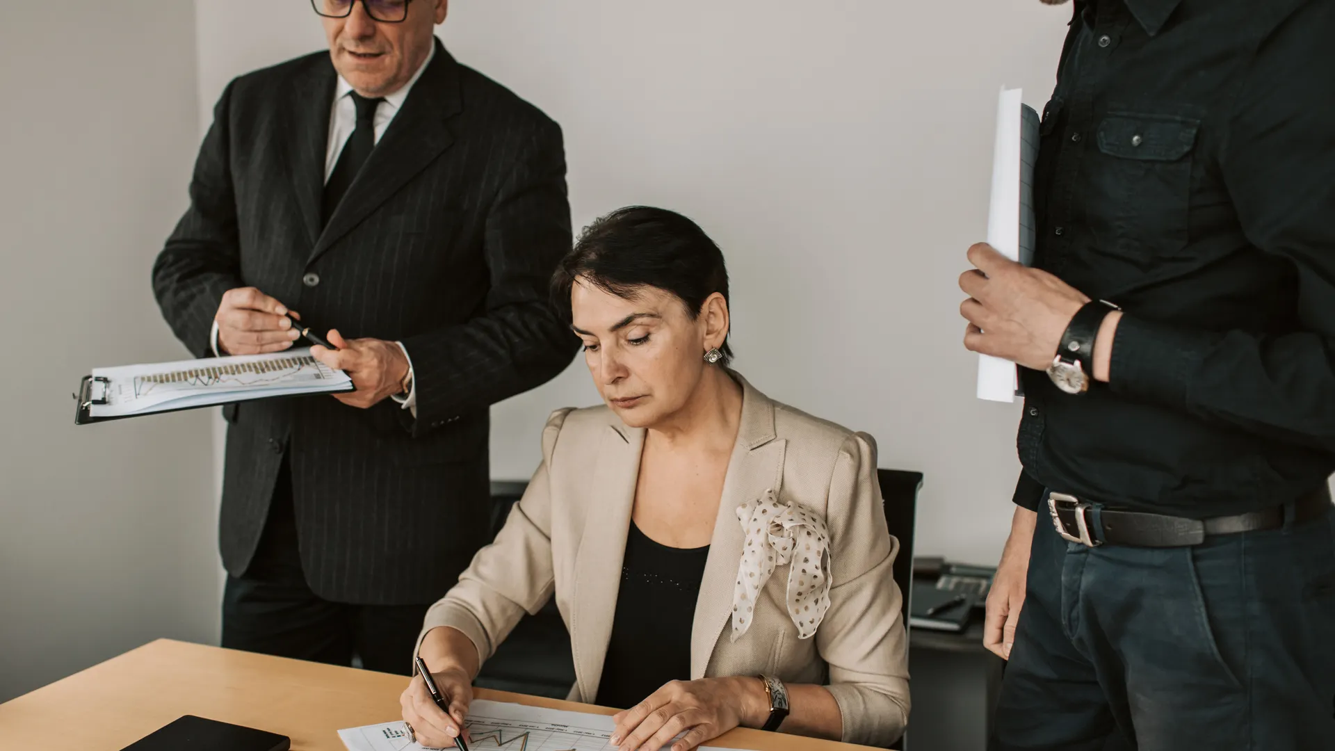Business professionals collaborating on financial documents in an office setting