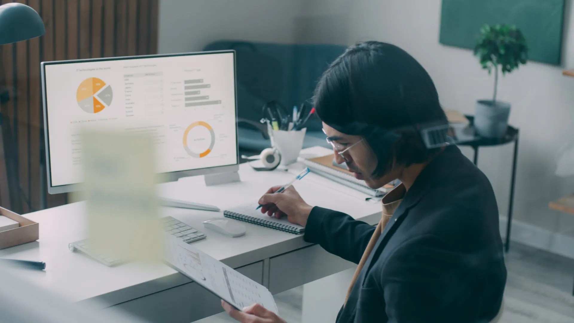 Business person reviewing analytics and charts at a modern office desk