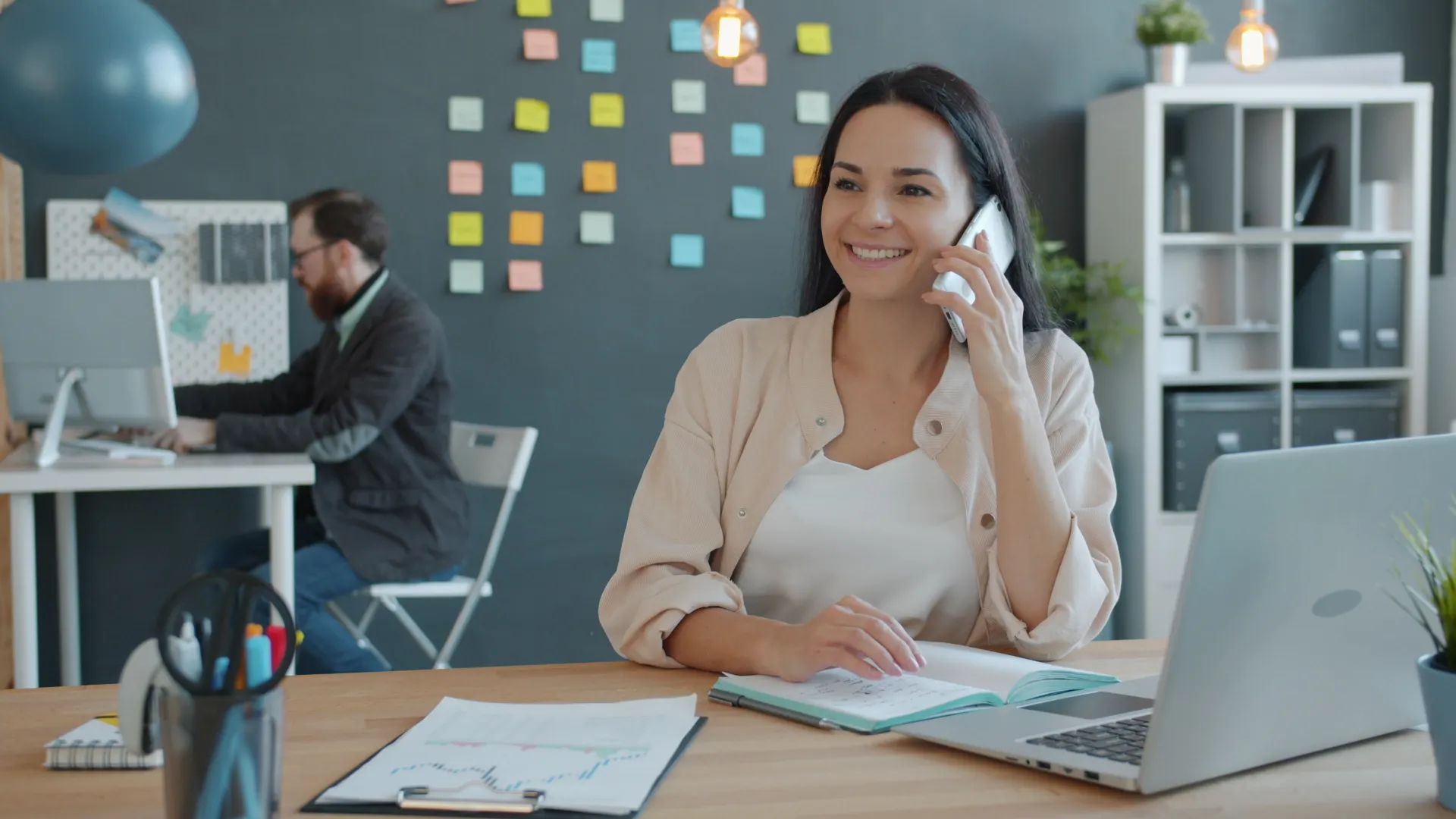 A woman on a phone call in a contemporary office setting