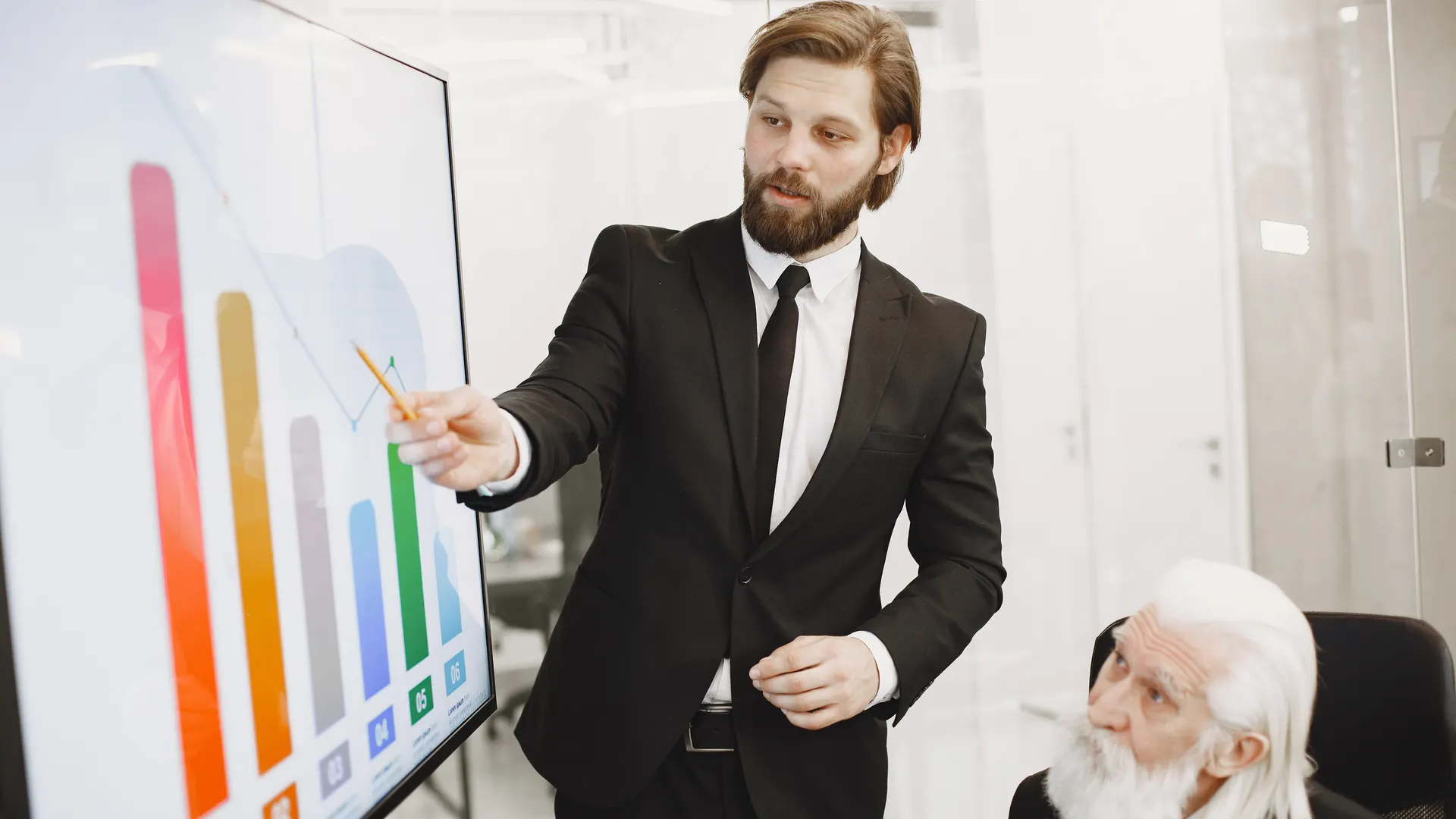 Two businessmen discussing data trends during a presentation in a modern office setting