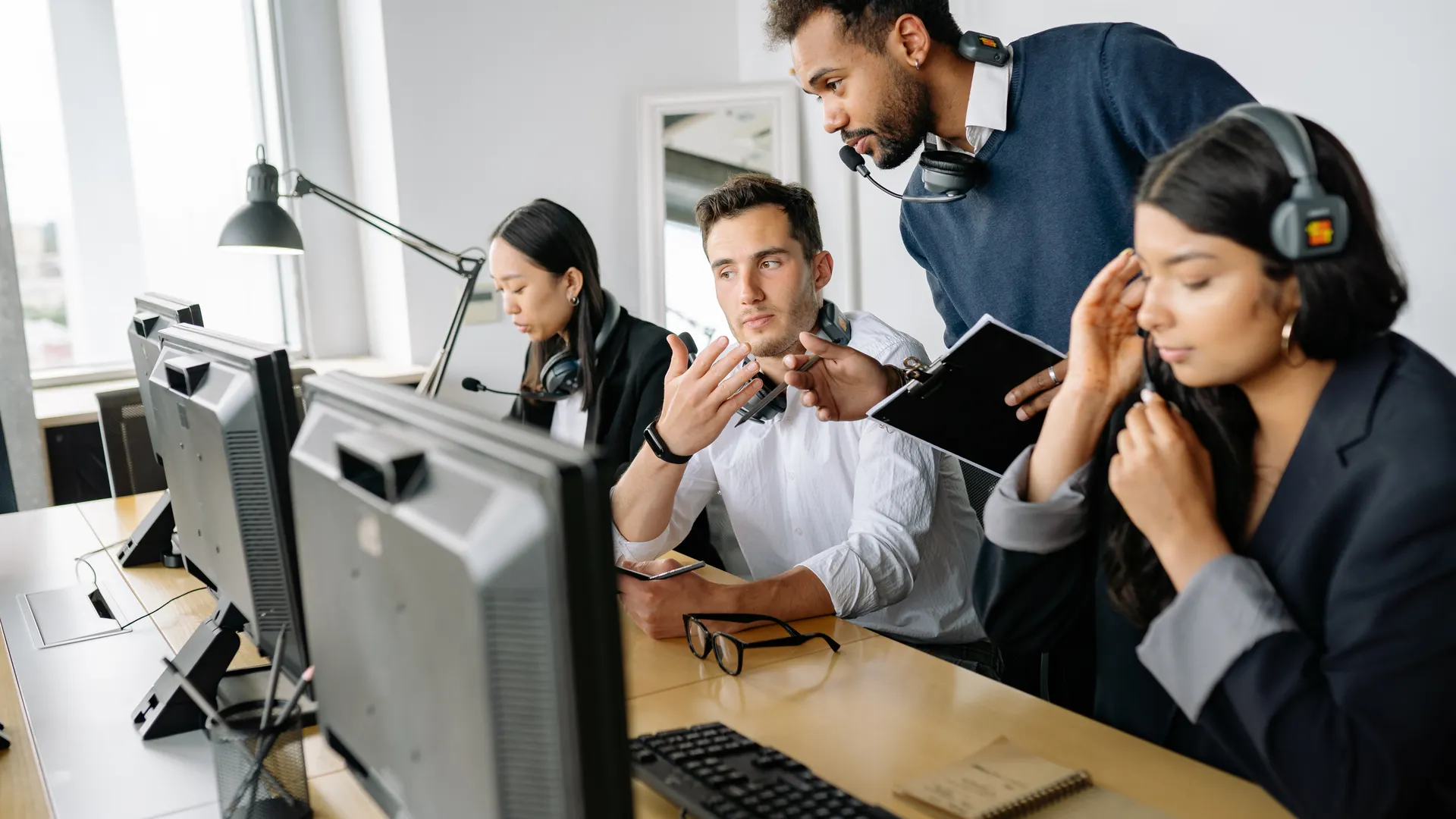 A diverse team of call center agents collaborating in a modern office environment
