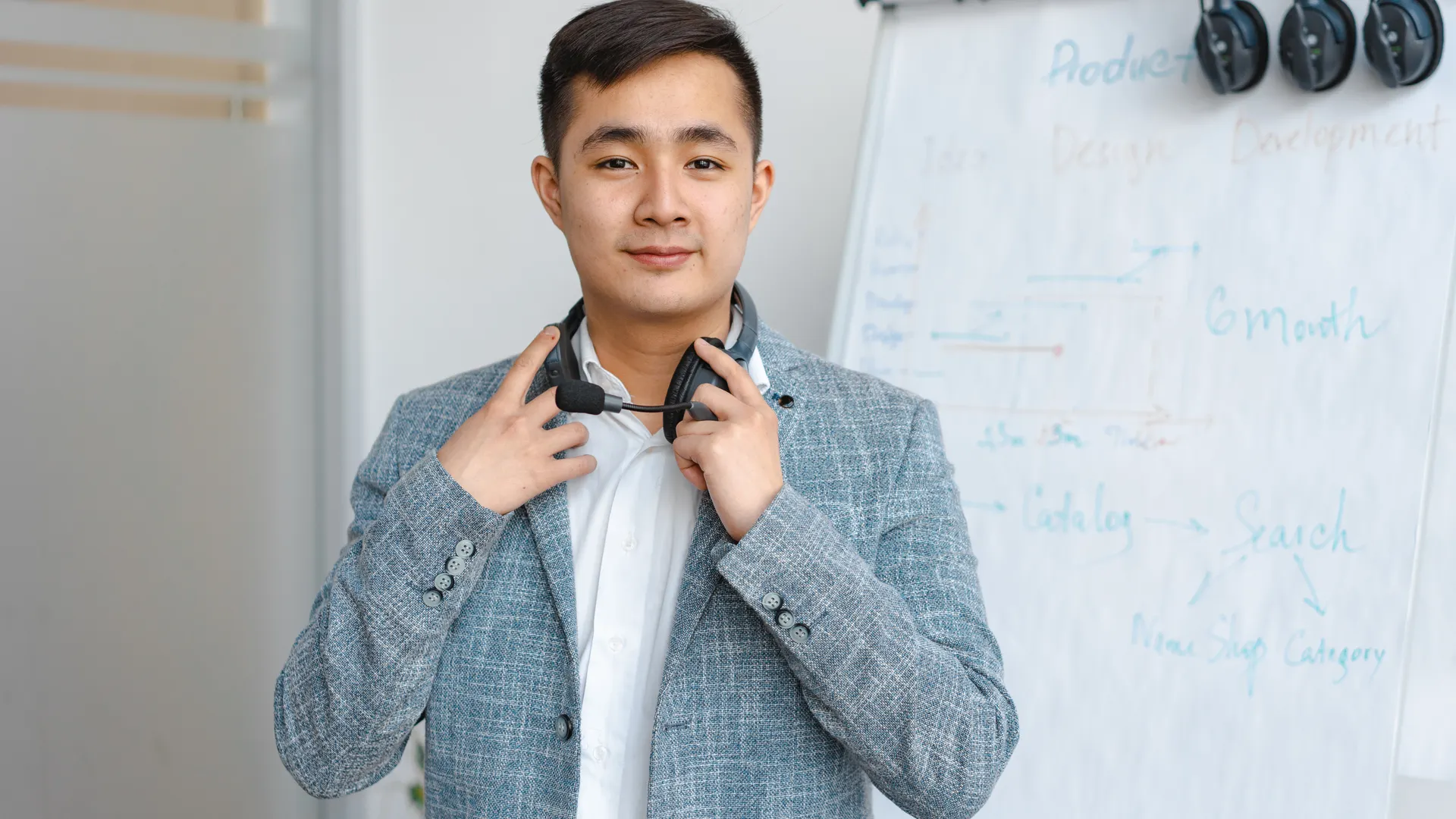 Portrait of a young man with a headset in a modern office environment