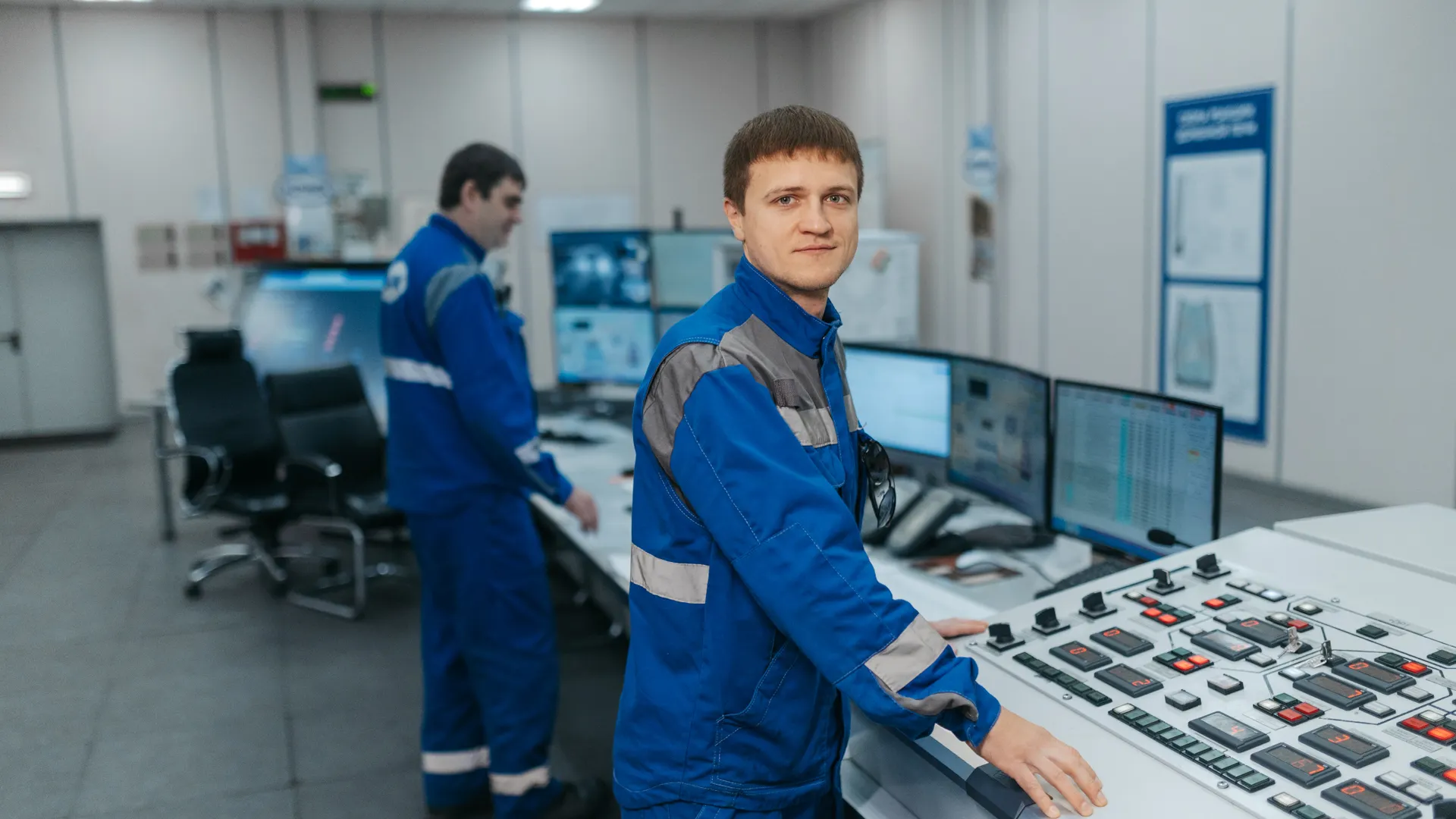 Two technicians operating machinery