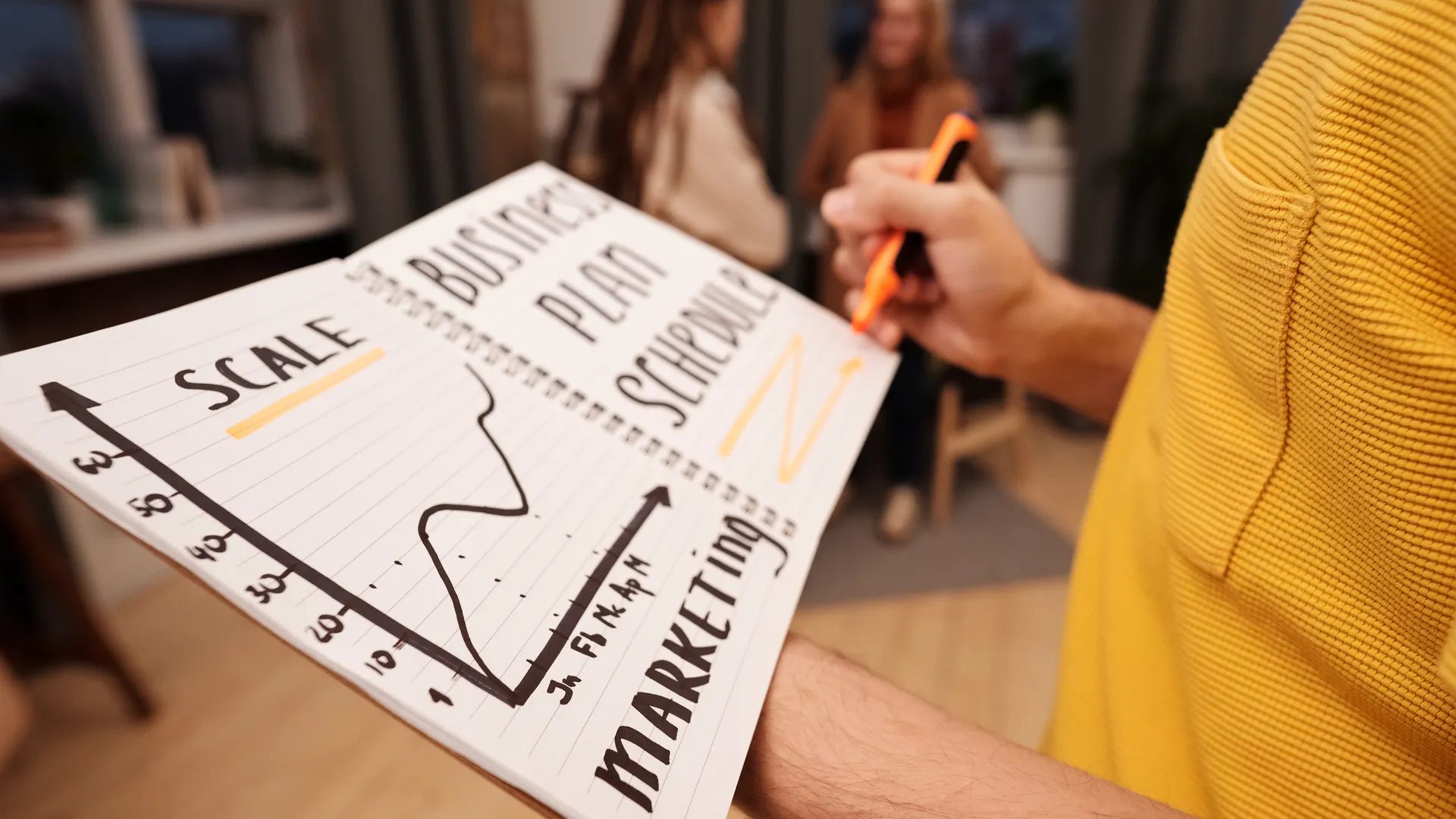 Close-up of a business notebook with marketing plans in a casual office environment