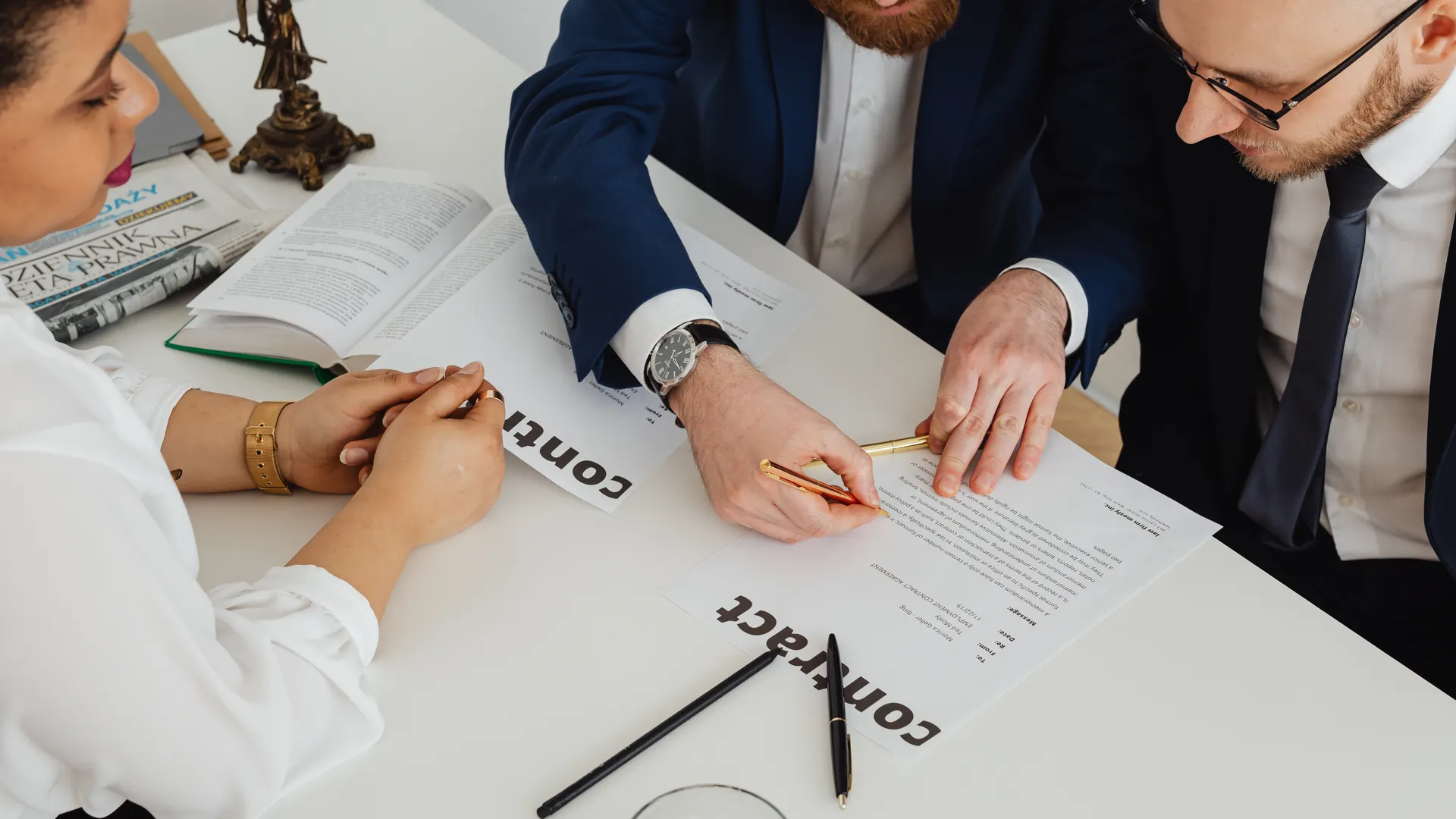Business professionals engaged in contract review at a modern office desk