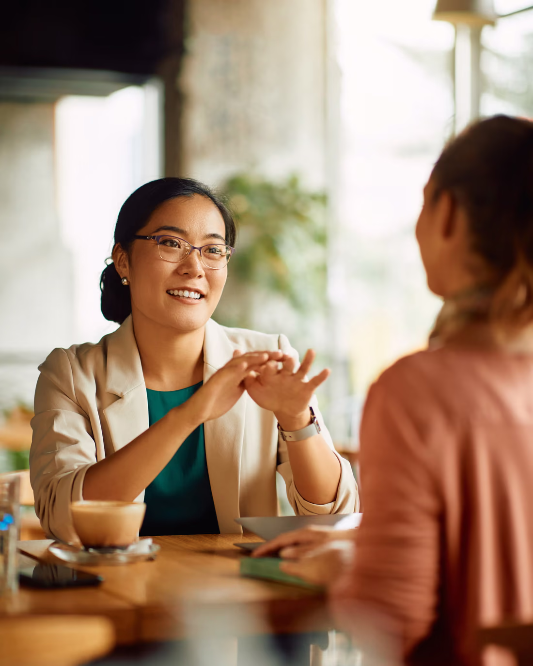 A team lead coaching an agent one to one, talking a low-scoring interaction through with her