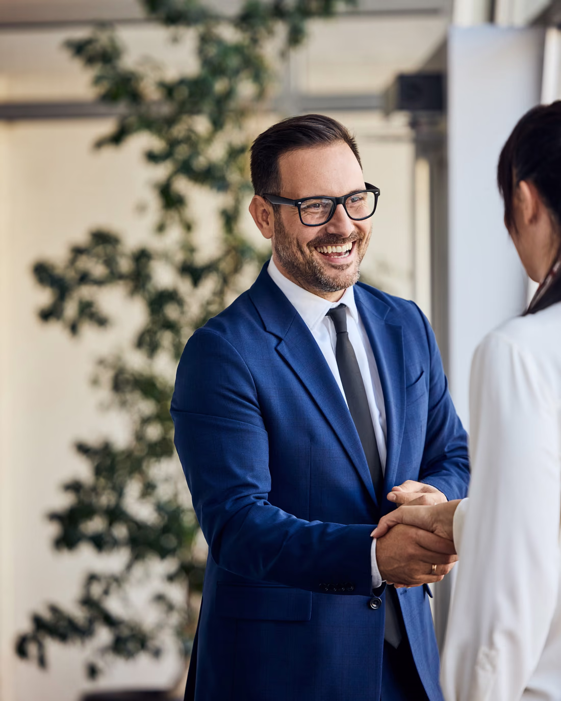 An account manager shaking hands with a customer after a detractor callback turned the relationship around